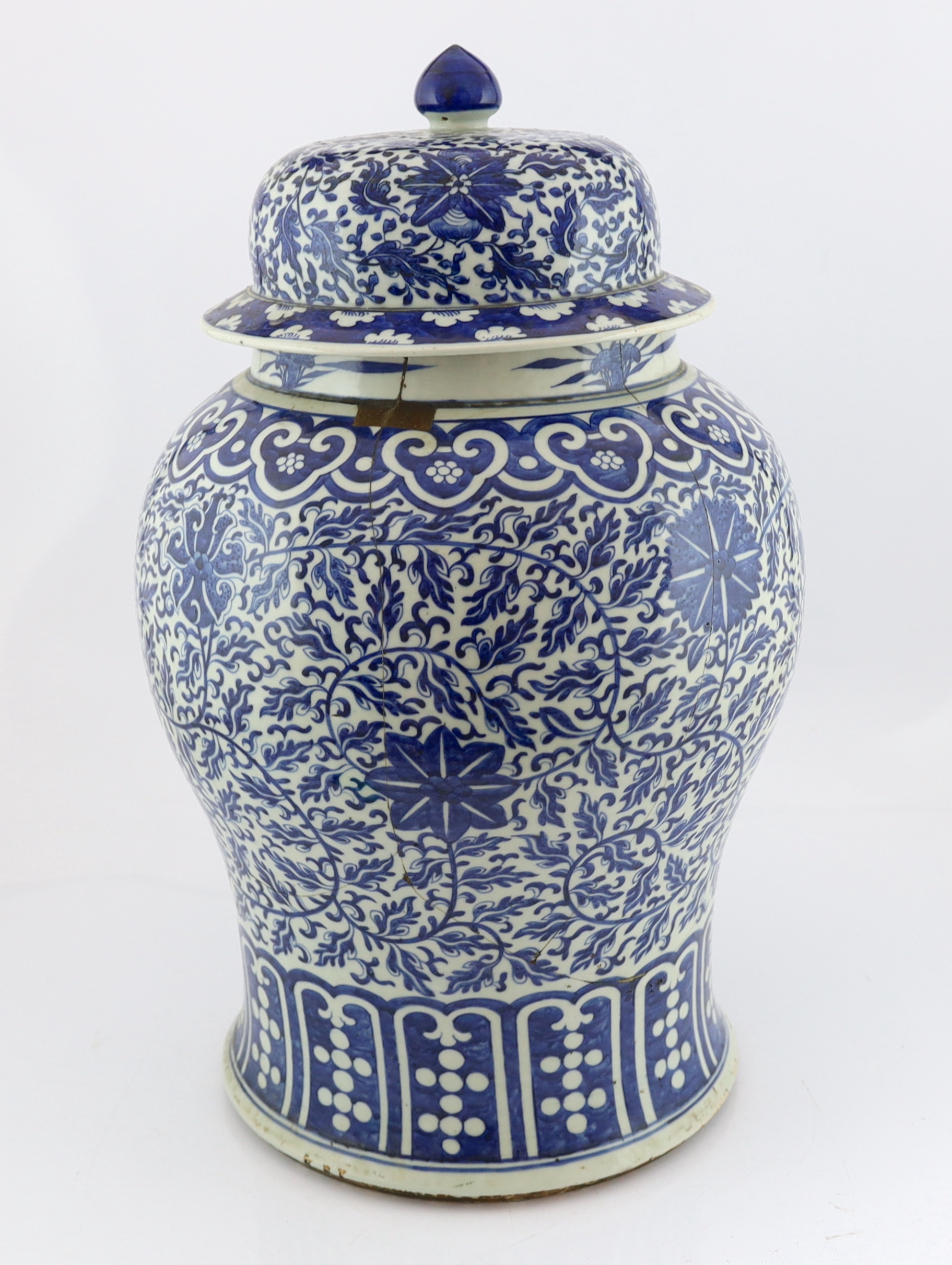 A massive Chinese blue and white ‘lotus’ vase and cover, 18th/19th century, broken and glued